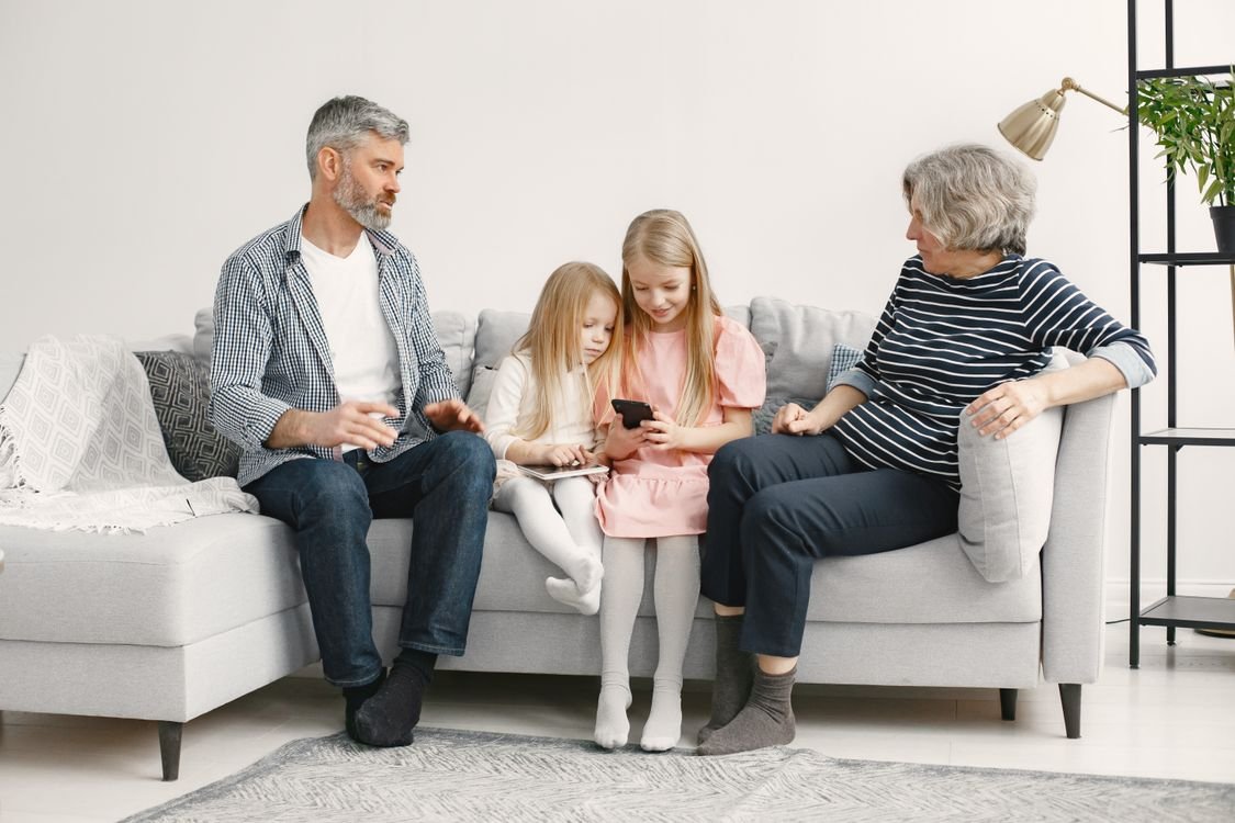 Stock photo of a family spending time together on a sofa